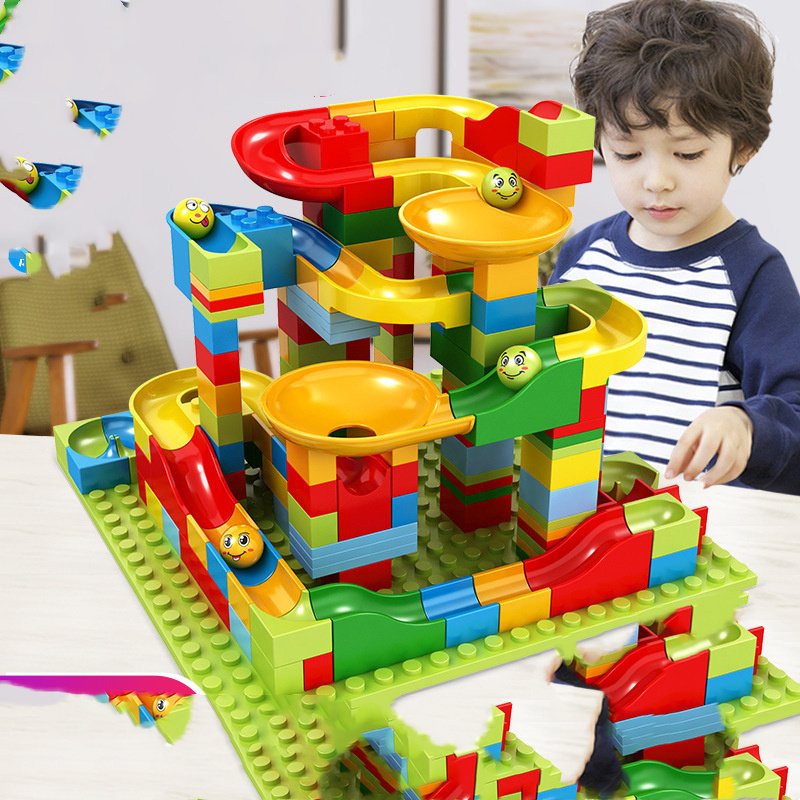 Kids building a marble race run with funnel slides – one of the best STEM toys for 6-year-olds
